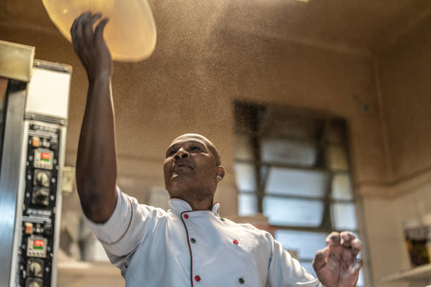 chef preparing a pizza - chef baker bakery flour imagens e fotografias de stock