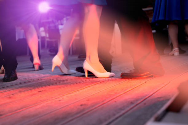 The dance floor with happy people dancing under the colorful lights