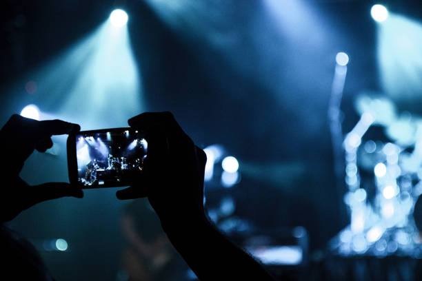 istock Filming concert on smart phone 1016890044