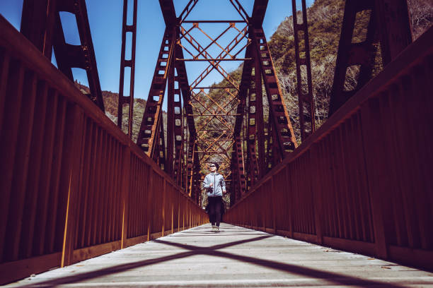 istock Asian lady running on the iron bridge 1016909686