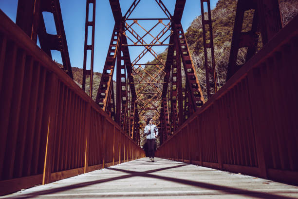 istock Asian lady running on the iron bridge 1016909688