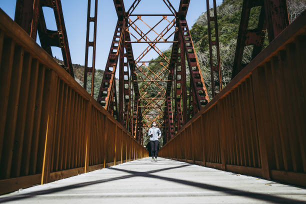 istock Asian lady running on the iron bridge 1016909690