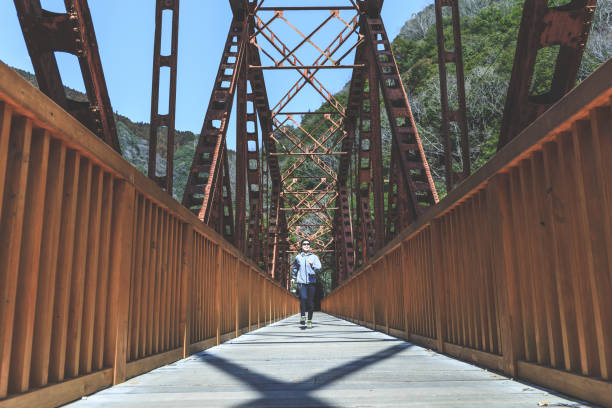 istock Asian lady running on the iron bridge 1016909712