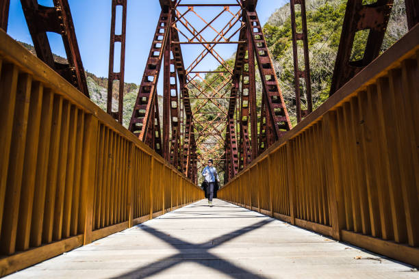 Asian lady running on the iron bridge