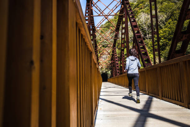 istock Asian lady running on the iron bridge 1016909756