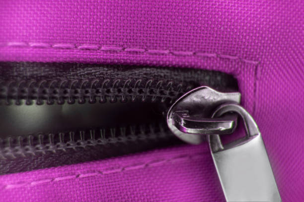 Black zipper in Purple fabric close up macro
