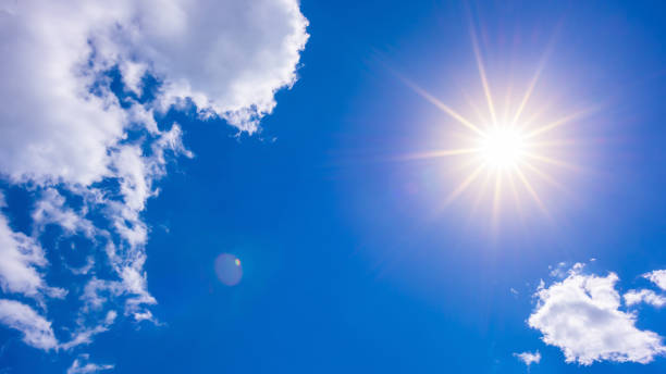 istock Sunny background, blue sky with white clouds and sun 1016919576