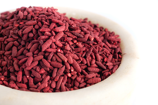 Red yeast fermented rice on mortar grinding bowl