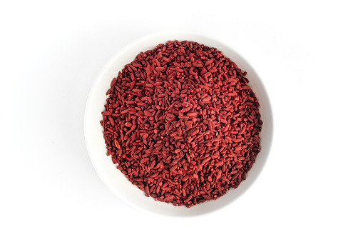 Red yeast rice on small white plate