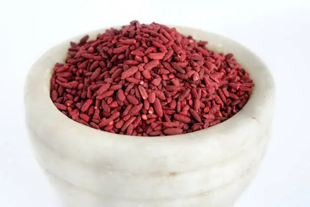 Red yeast fermented rice on mortar grinding bowl