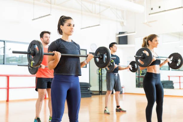 istock Bodybuilders Lifting Weights While Standing In Gym 1016947538