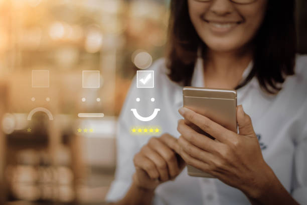 Customer service evaluation concept. Businesswoman pressing face emoticon on virtual touch screen at smartphone .Customer service evaluation concept. product review stock pictures, royalty-free photos & images