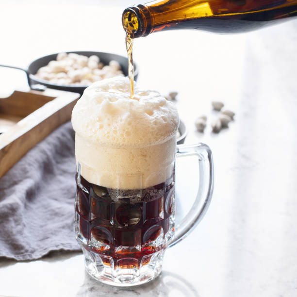 istock Man pouring beer into glass 1016964346