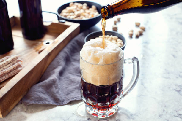 istock Man pouring beer into glass 1016964352