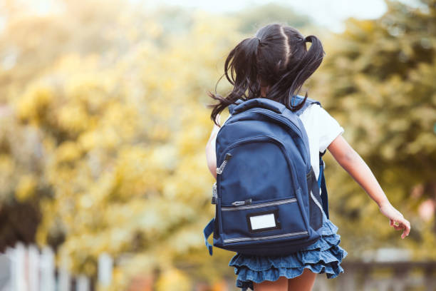 Cute asian child girl with backpack running and going to school Back to school. Cute asian child girl with backpack running and going to school with fun rucksack stock pictures, royalty-free photos & images