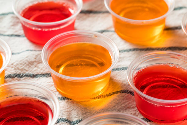 Homemade Sweet Alcoholic Gelatin Shots Homemade Sweet Alcoholic Gelatin Shots in Plastic Cups gelatin stock pictures, royalty-free photos & images