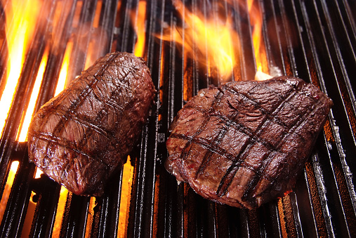 Two beefsteaks on barbecue grill
