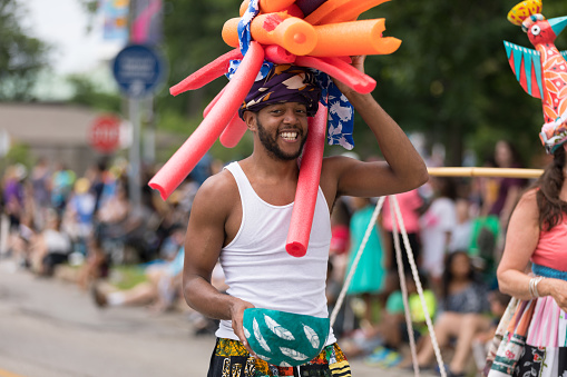 Cleveland, Ohio, USA - June 9, 2018 African american man wearing a hat made up of foam cylinders At the abstract art festival Parade The Circle