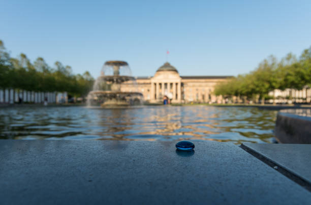 Kurhaus Weisbaden Fountains Kurhaus Weisbaden Fountains with a focus on a blue pebble in the foreground kurhaus casino stock pictures, royalty-free photos & images