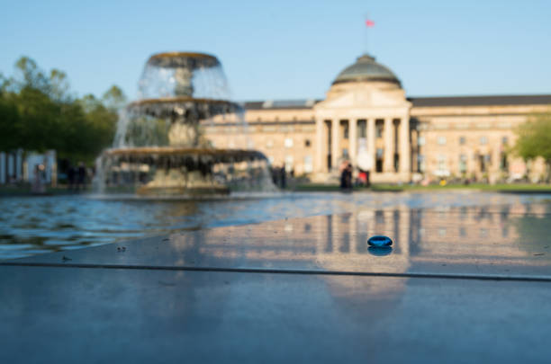 Kurhaus Weisbaden Fountains Kurhaus Weisbaden Fountains with a focus on a blue pebble in the foreground kurhaus casino stock pictures, royalty-free photos & images