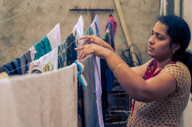 istock Indian woman drying clothes 1017008320
