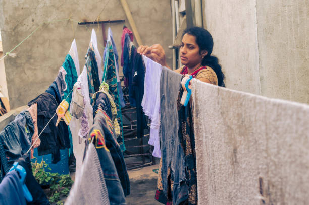 istock Indian woman drying clothes 1017008356