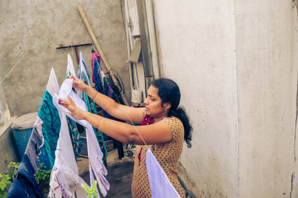 istock Indian woman drying clothes 1017008452