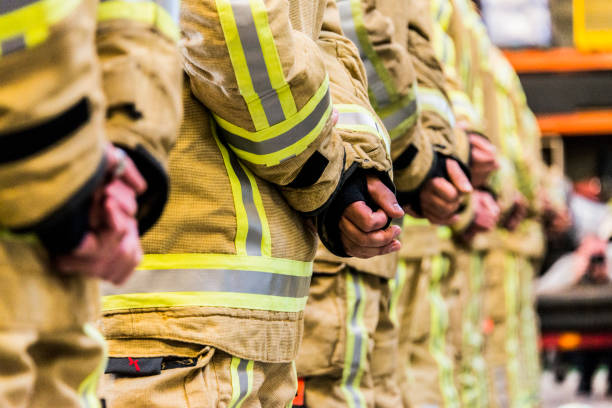 Firefighter equipment fire resistant trousers and helmet emergency services stock photo