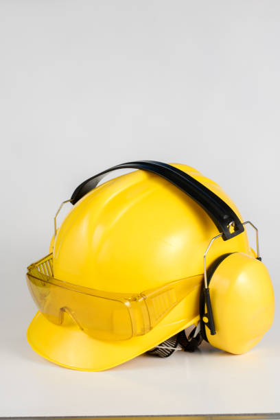 istock Helmet and hearing protection on a white table. Safety and hygiene accessories for construction workers. White background. 1017018892