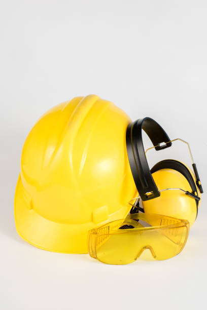 istock Helmet and hearing protection on a white table. Safety and hygiene accessories for construction workers. White background. 1017019080
