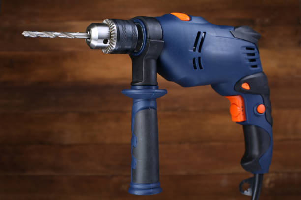 istock Electric drill on wooden background. Closeup 1017024524