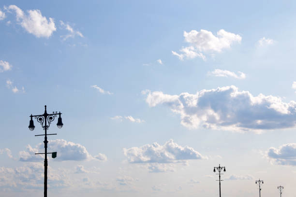 Street lights against the blue sky with clouds