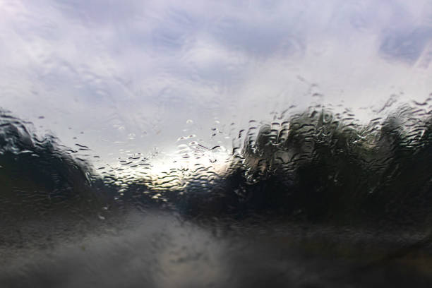 istock Water drops on a blurred rainy driving road 1017038710