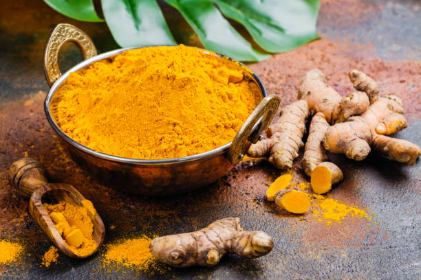 istock Turmeric powder and fresh root on grunge background 1017046536