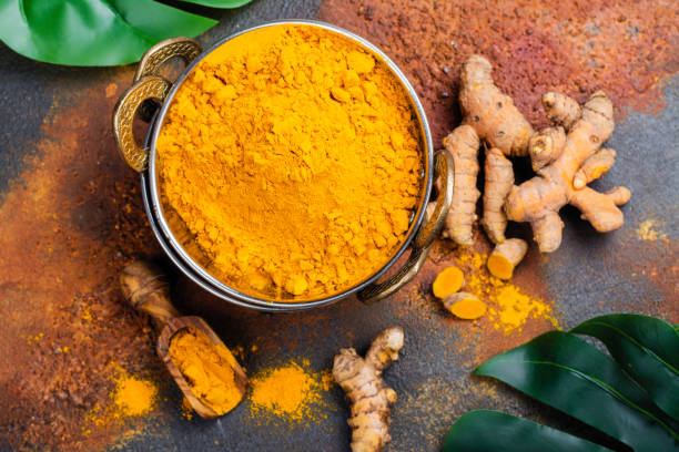 istock Turmeric powder and fresh root on grunge background 1017046578