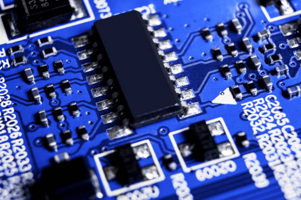 istock Macro shot of a Circuitboard with resistors microchips and electronic components. Computer hardware technology. Integrated communication processor in blue tones. Semiconductor. PCB. Closeup 1017049318