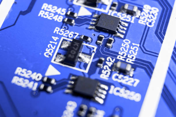 istock Macro shot of a Circuitboard with resistors microchips and electronic components. Computer hardware technology. Integrated communication processor in blue tones. Semiconductor. PCB. Closeup 1017051784