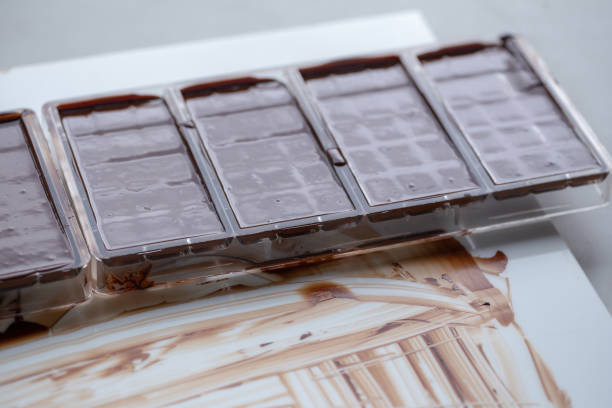 istock Preparation of dark chocolate bars made from scratch using cocoa butter and sugar 1017065246