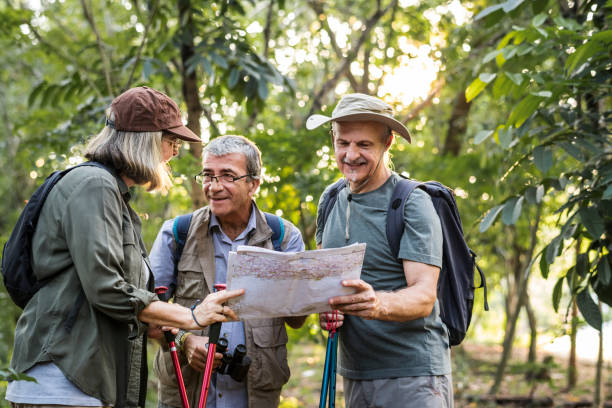 istock Group of senior trekkers checking a map for direction 1017067470