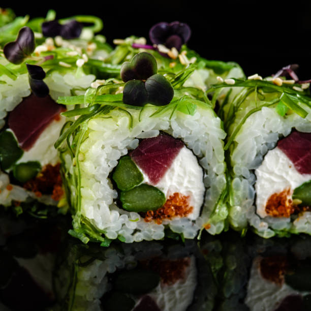 istock Close-up of traditional japanese sushi on a dark background with reflection. 1017068430