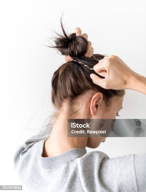 Woman Making Hair Bun Stock Photo - Download Image Now - Hair, Tying, Rear  View - iStock