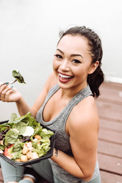 istock fitness woman eating a salad 1017076384