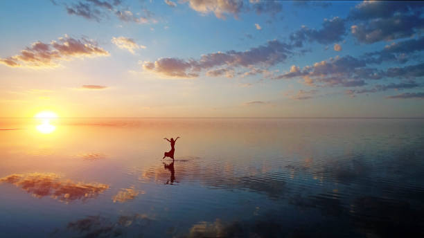 Ballerina dancing on the lake at sunset. Ballerina dancing on the lake 
Salt Lake /Anatolia - Turkey ballerina shadow stock pictures, royalty-free photos & images