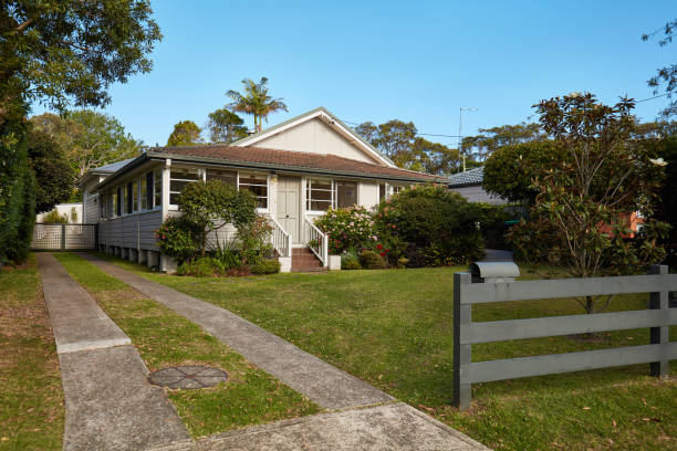 istock Lawn and driveway in front yard against house 1017087348