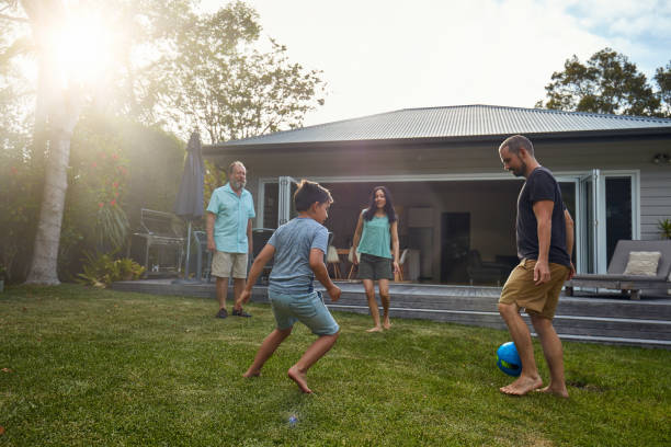 istock Multi-generation family playing soccer in yard 1017087374