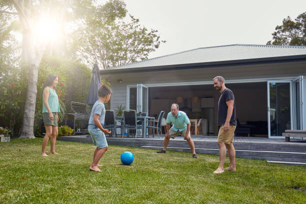istock Boy playing soccer with parents and grandfather 1017087376