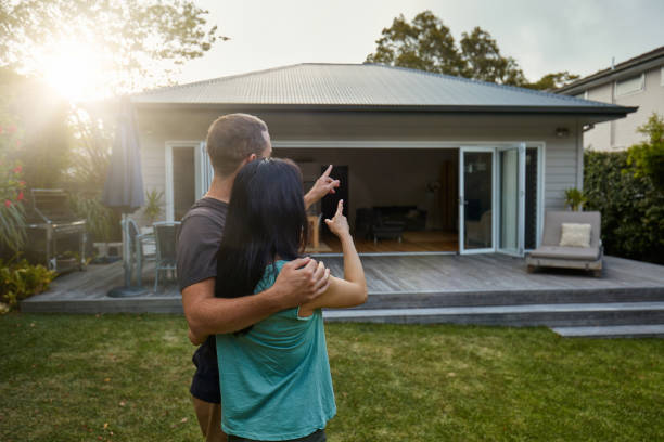 istock Mid adult couple pointing while standing on lawn 1017087446