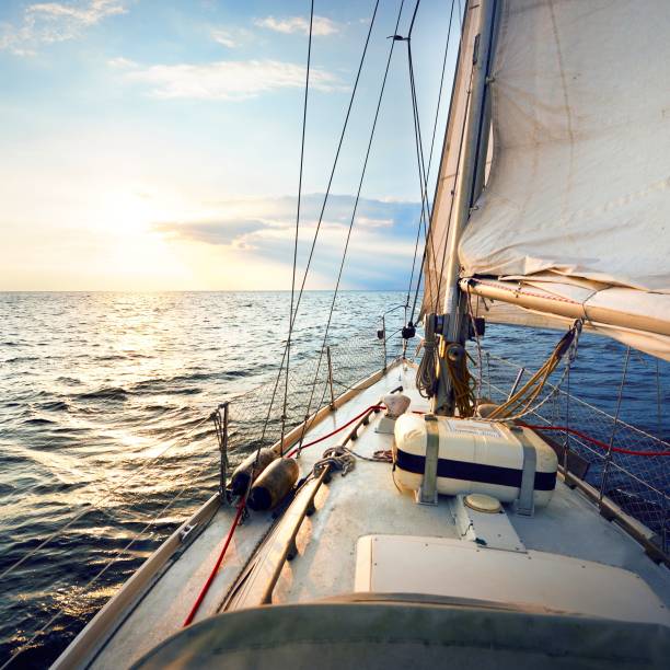 istock Sailing at sunset, a view from the yacht’s deck to the bow and sails 1017094682