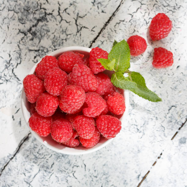istock Fresh raspberries in a bowl, top view. 1017097700