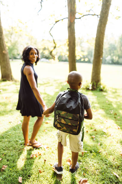 istock mom take the son back to school 1017099994